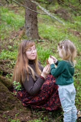 Matka ukazuje dceři šišku