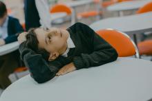 školák ležící na lavici