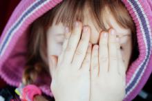 dívka s rukama přes oči