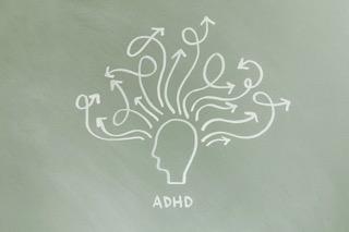 Kreslená hlava s nápisem ADHD